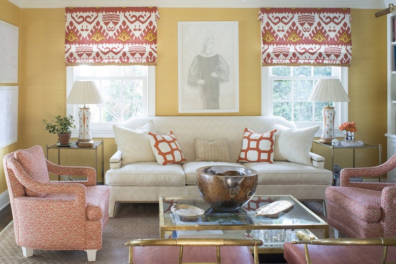 Living room with yellow walls and ikat print coral