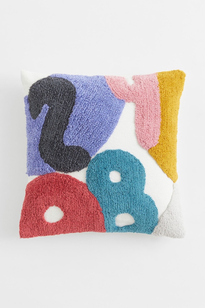 A pillow pillow with different numbers in a tufted texture and various fun colors.