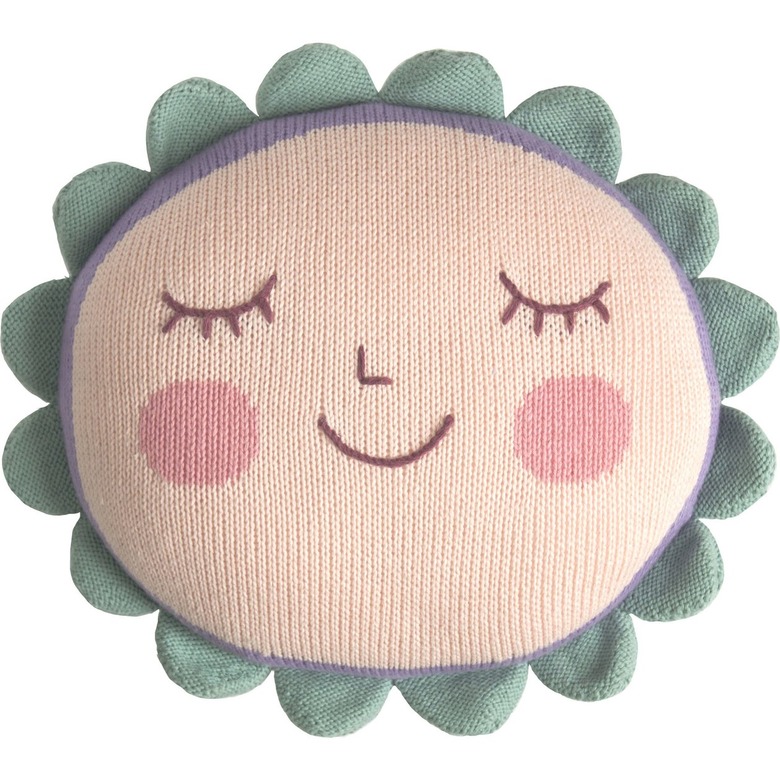 A light pink pillow featuring a face with a nose
