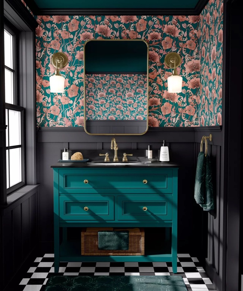 Black bathroom with floral wallpaper and teal vanity.