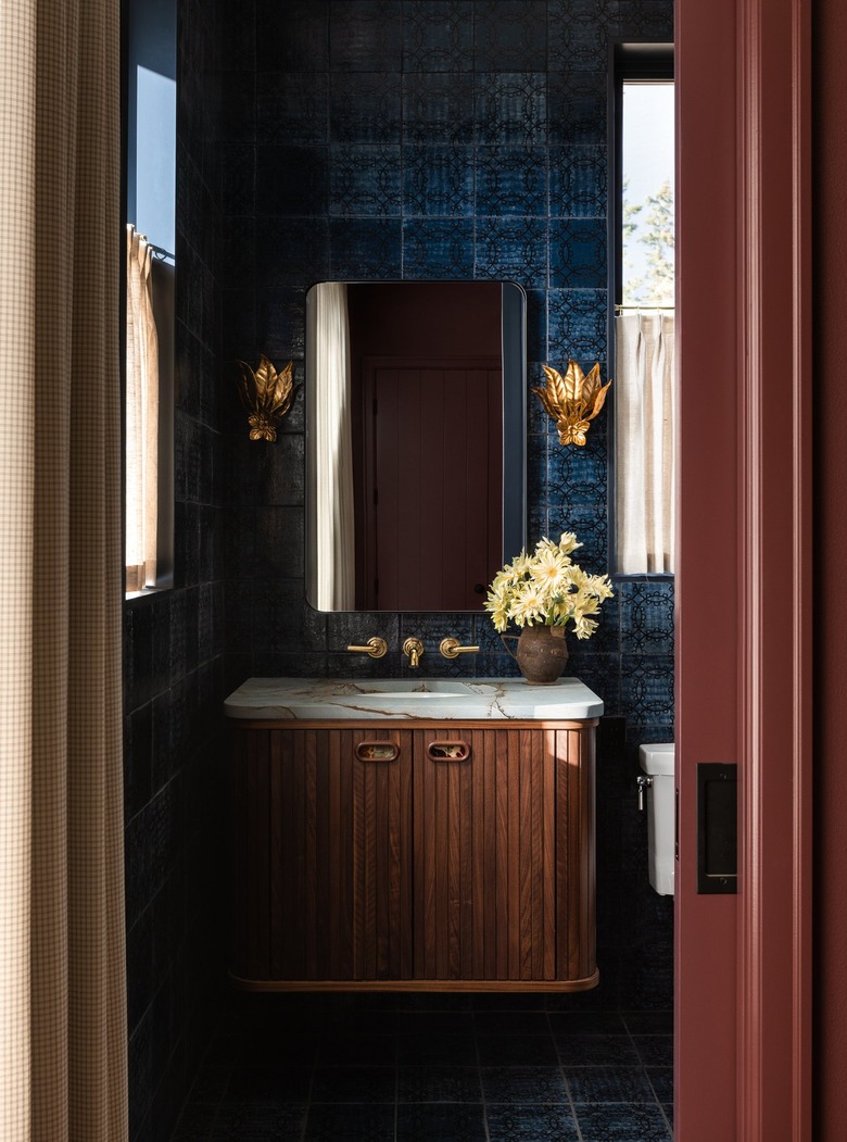 Dark bathroom with navy tiled walls