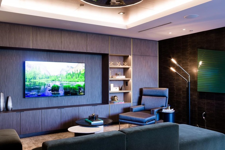 dark wood built in media storage in dark living room