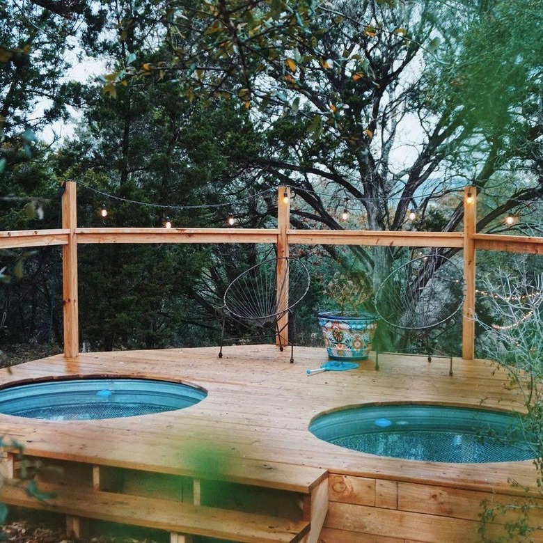 two above ground stock tank pools with deck