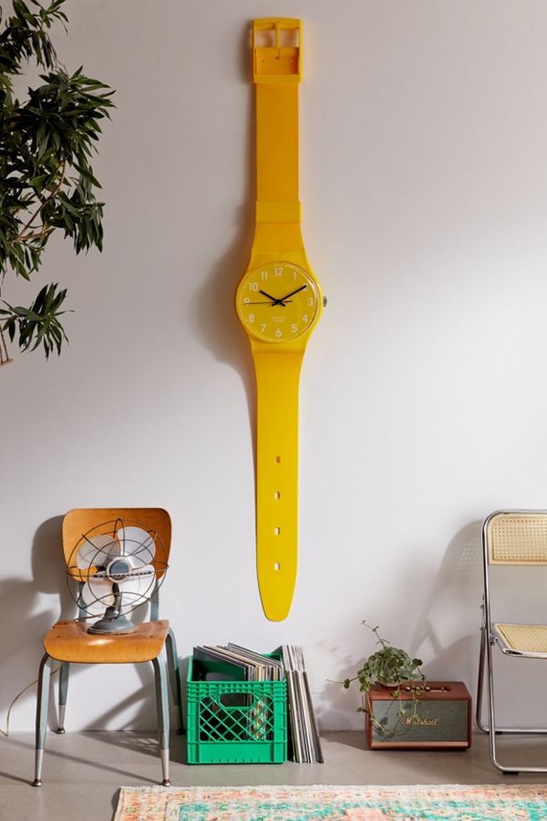 large yellow watch on wall near chair