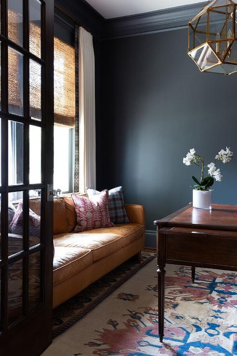 brown sofa in a black room