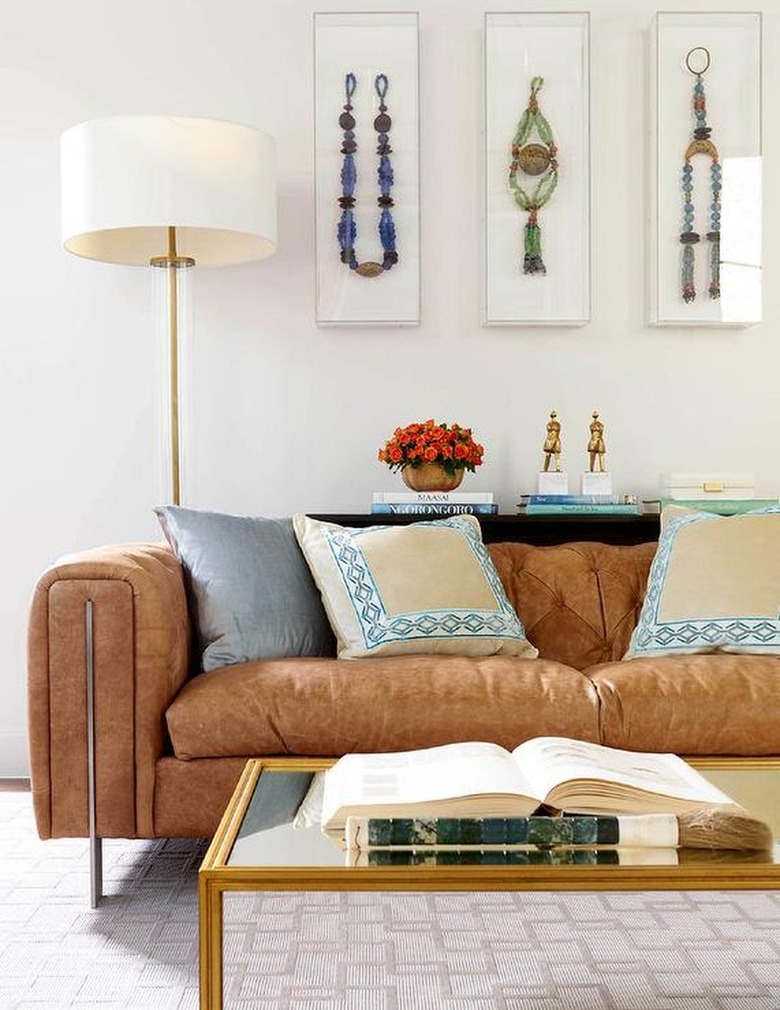 brown leather sofa with gold table