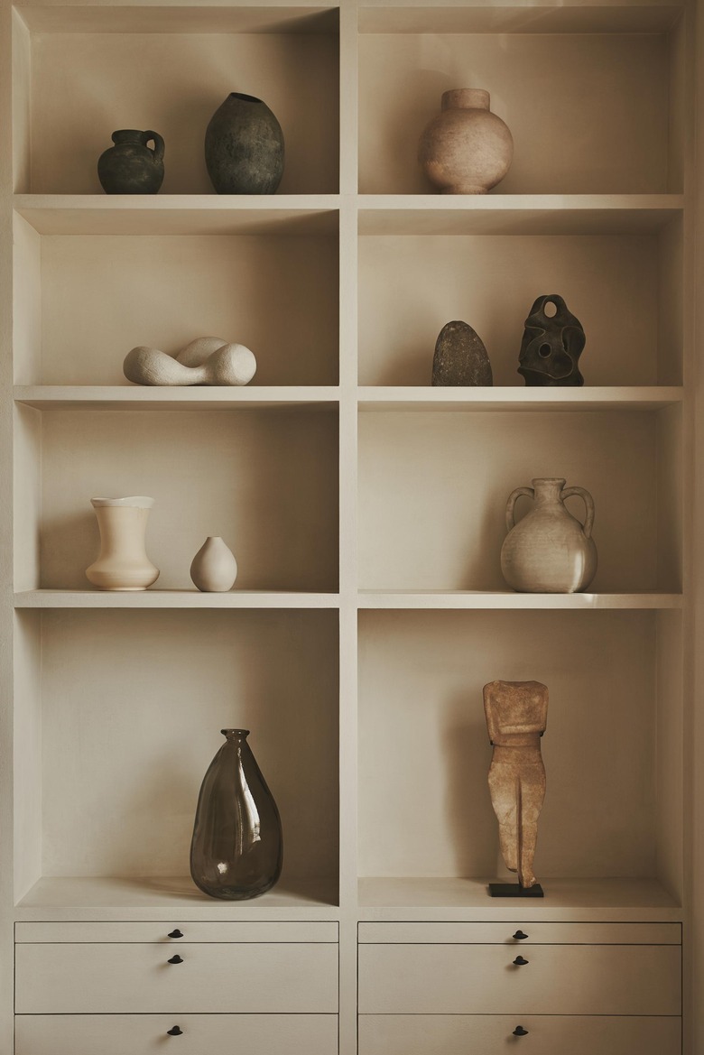 bookcase styled with ceramics and art objects