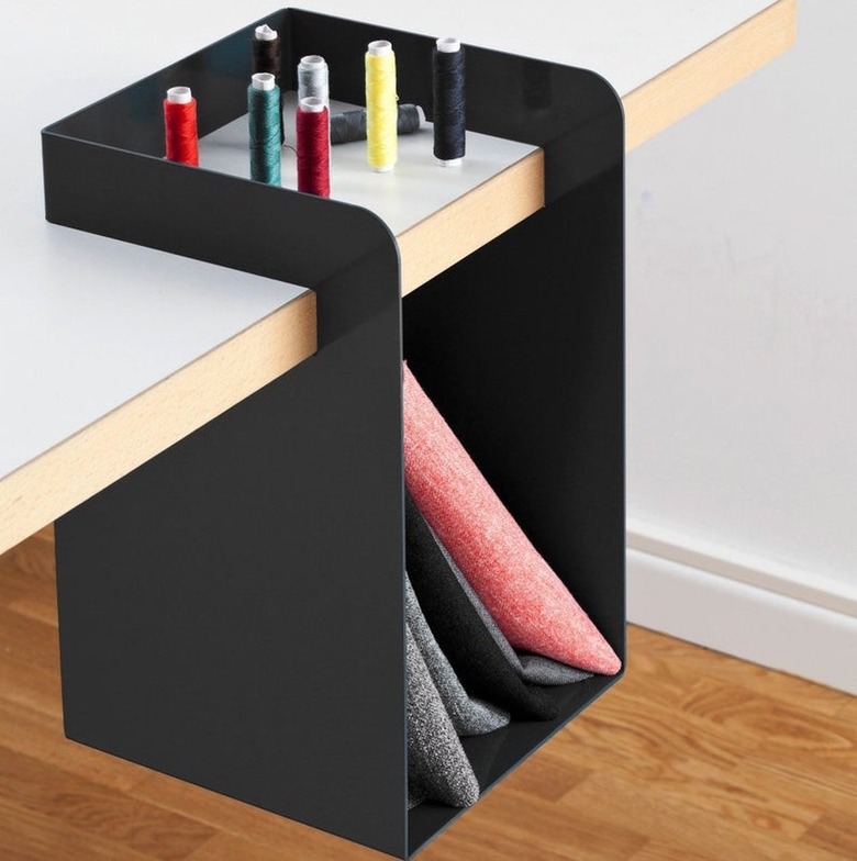 one portion of a light desk with a black storage hanging shelf