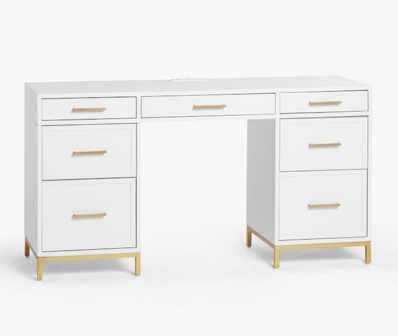 white lacquered desk with gold hardware and drawers for storage