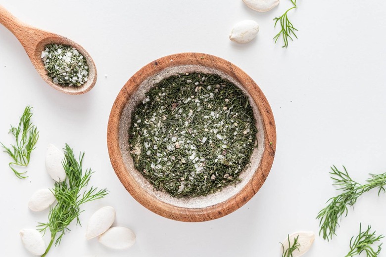 A small wood bowl filled with dried dill