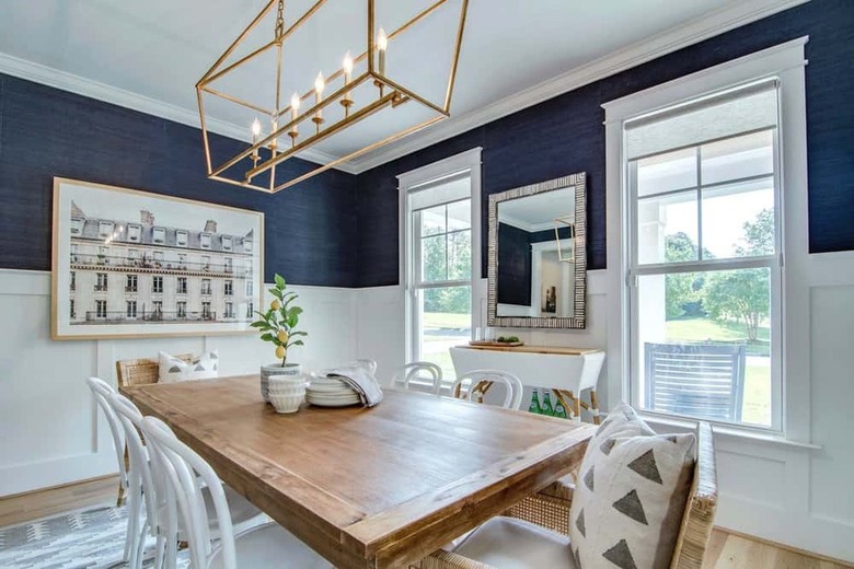 Blue and white dining room with wood table and lemon tree centerpiece.