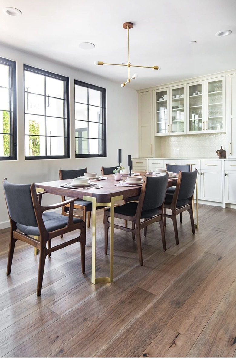 Wood dining room table with gold legs.