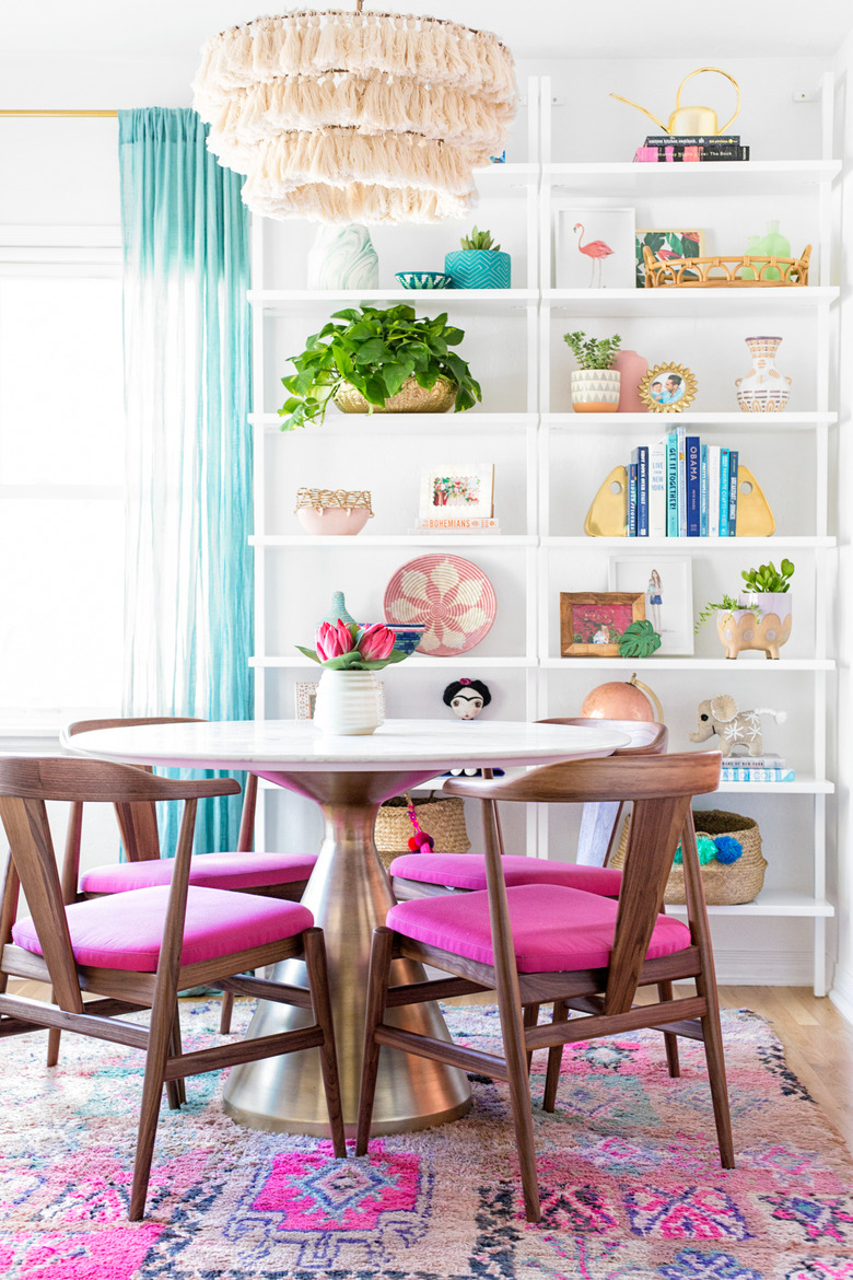 colorful dining room with bohemian tassel pendant light and white open shelving