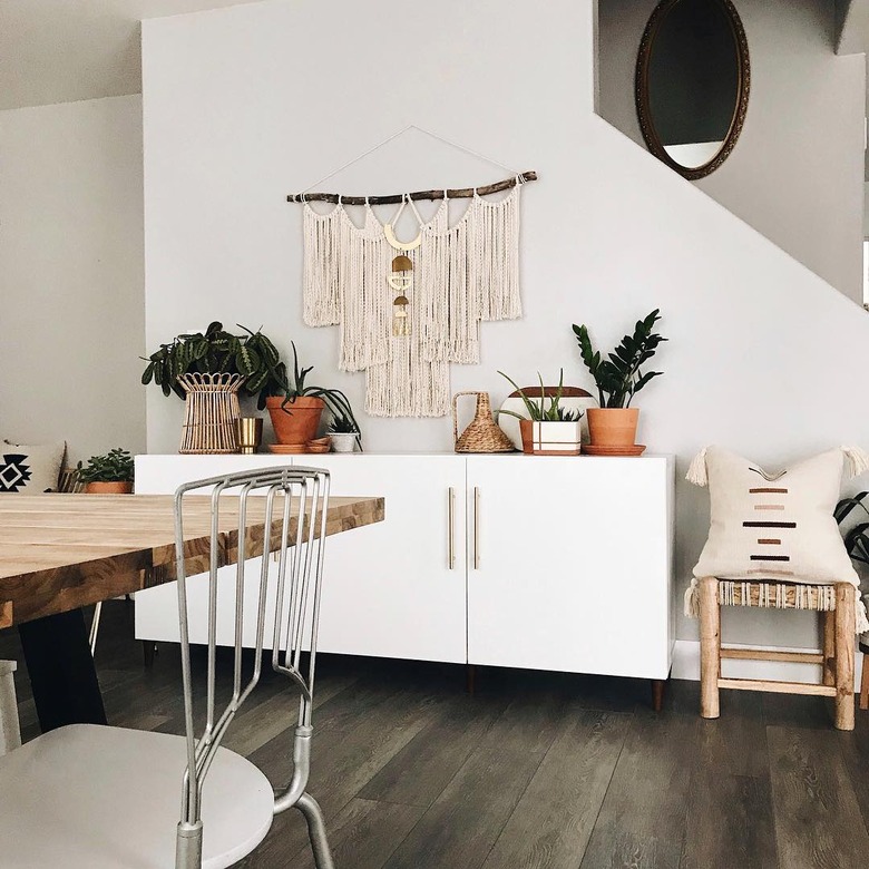 bohemian dining room with white buffet for storage