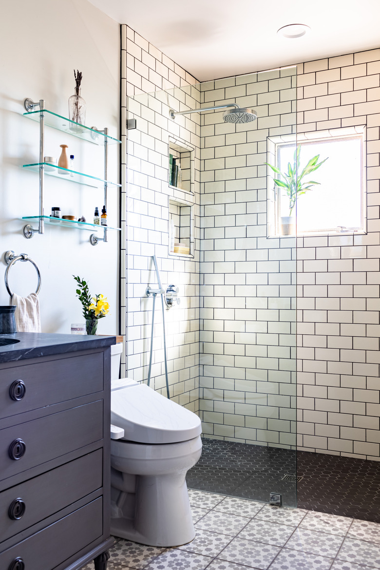 bathroom with shower with subway tile walls