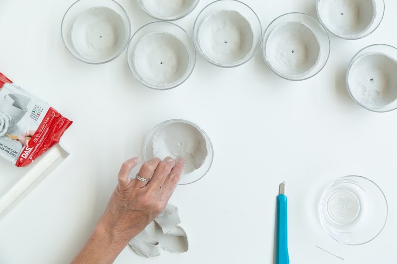 Pressing air-dry clay into small glass bowl
