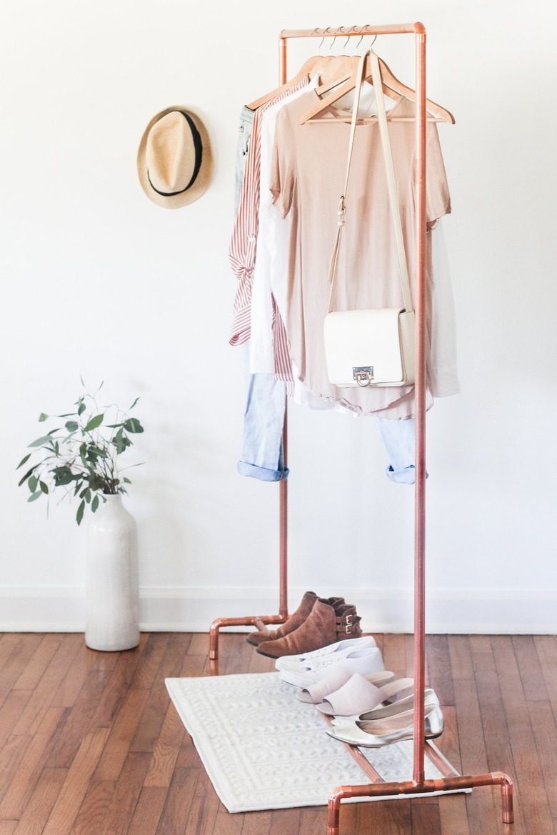 a clothing rack with a shoe rack attached made from copper pipe
