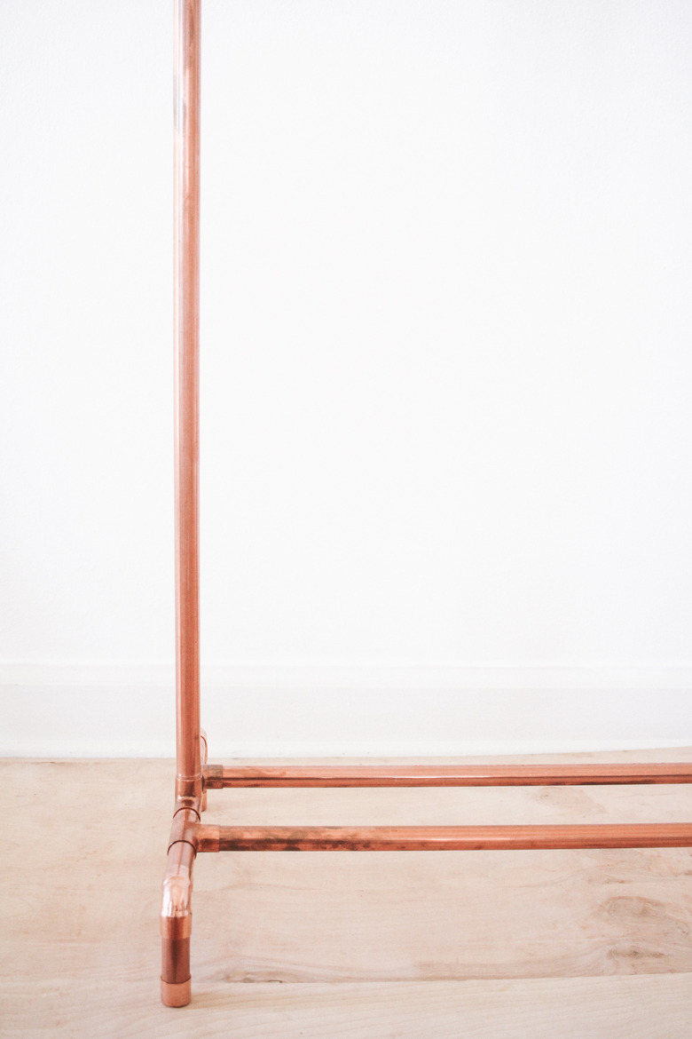 Vertical pipe inserted into leg of clothing stand