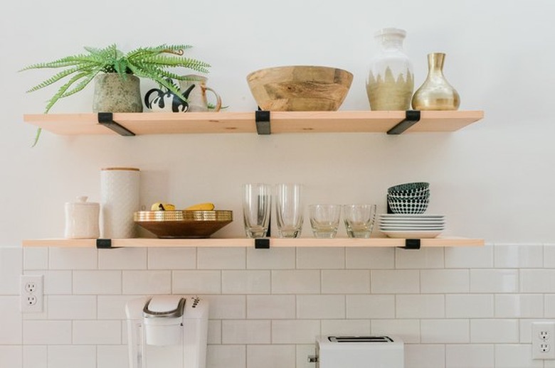 Open kitchen shelving with dishes in white kitchen