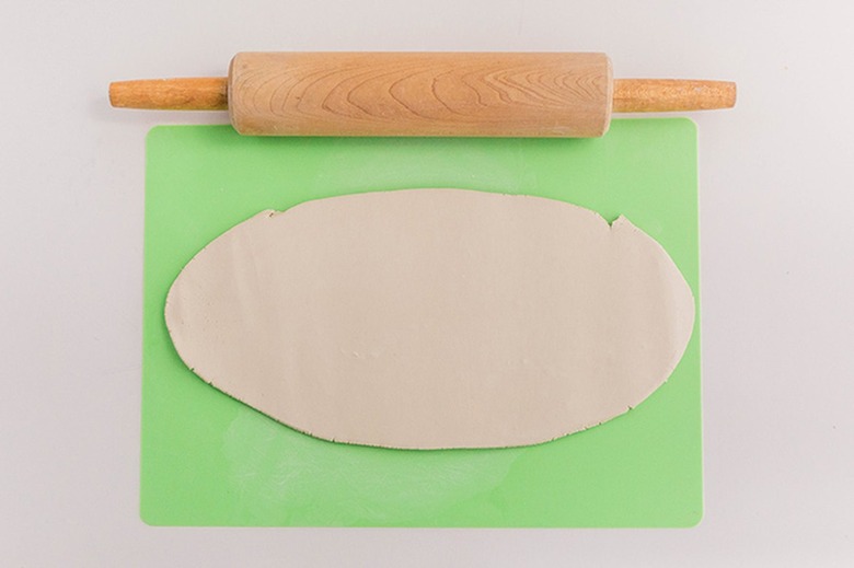 Roll clay out flat until it's about 1/4-inch thick.