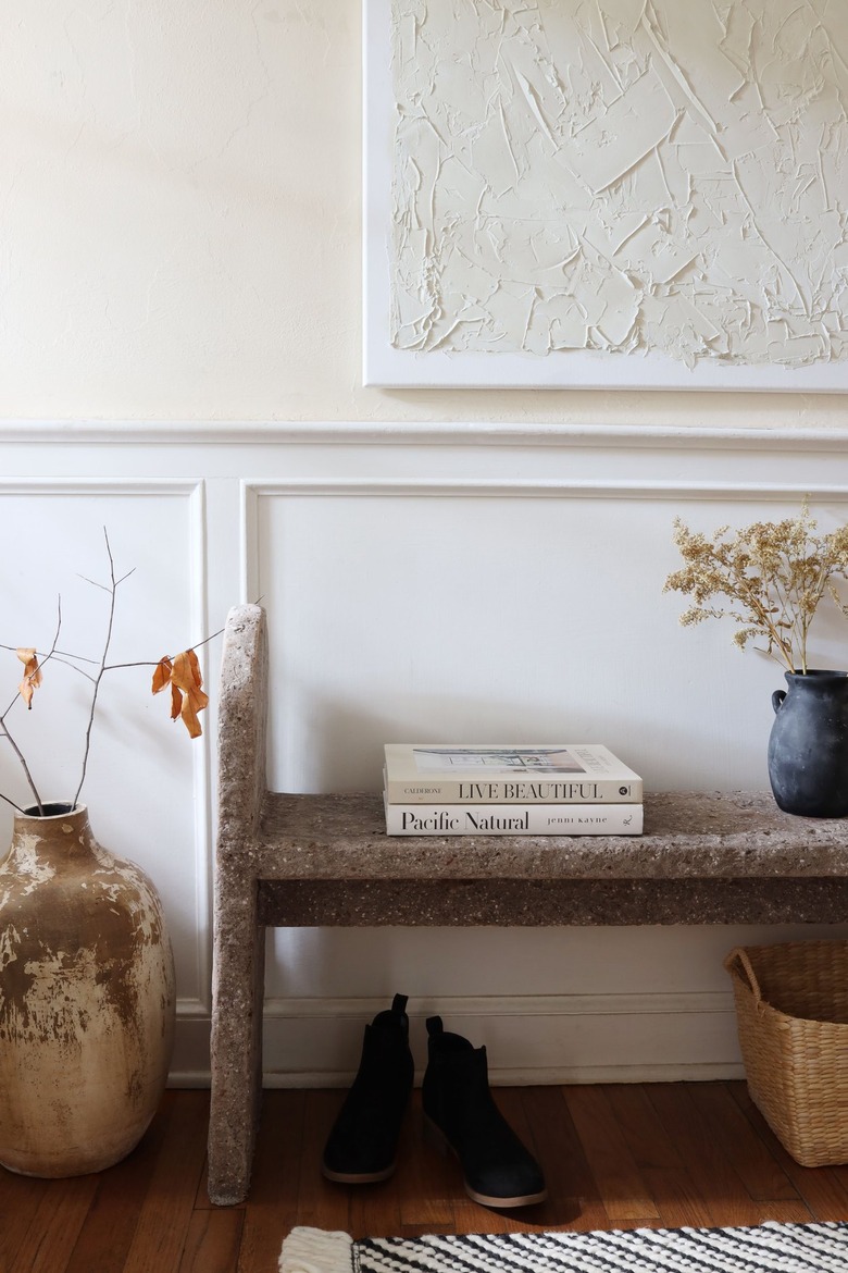 DIY limestone hypertufa bench in entryway with shoes and basket