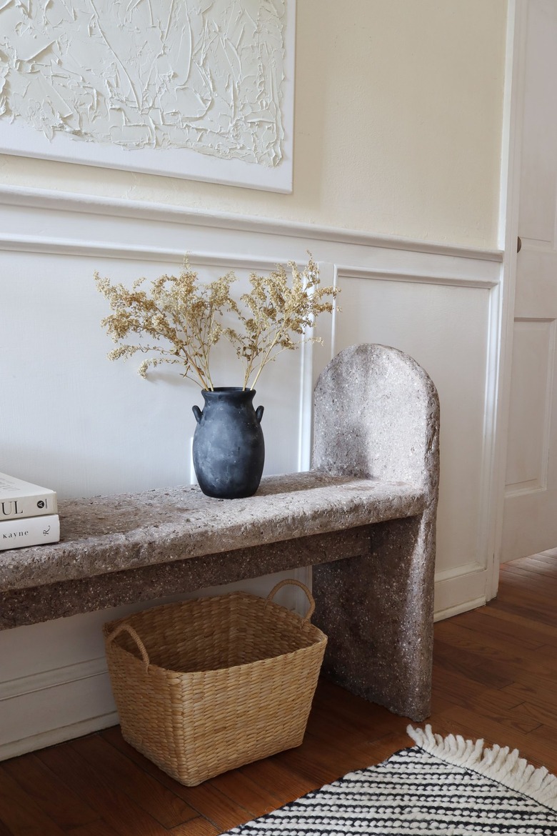 DIY limestone hypertufa bench in entryway with shoes and basket