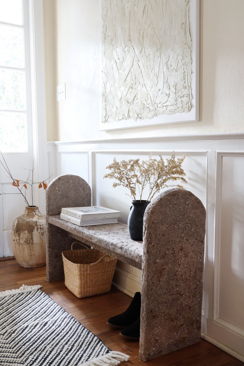 DIY limestone hypertufa bench in entryway with shoes and basket