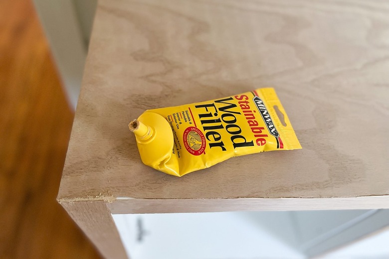 Wood filler piped in space between wood veneer pieces