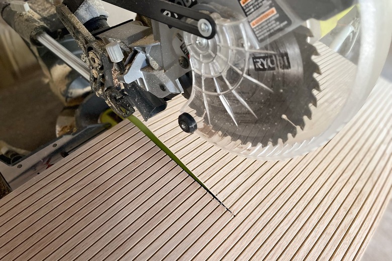 Cutting pole wrap sheet with power saw