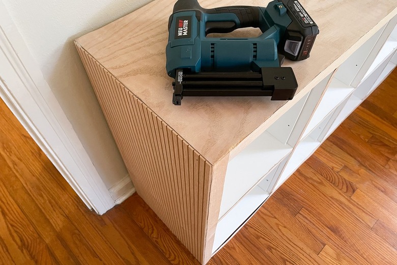 Pole wrap glued and nailed to side of IKEA Kallax shelf