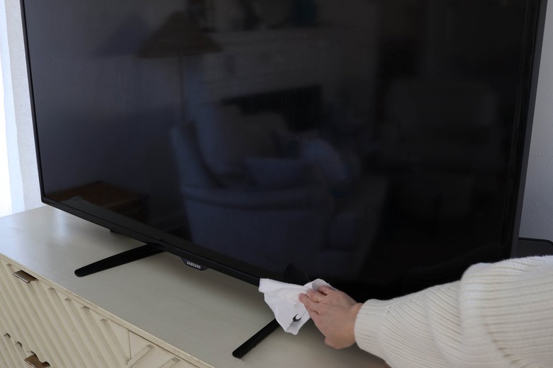 Wiping television with lint free cloth