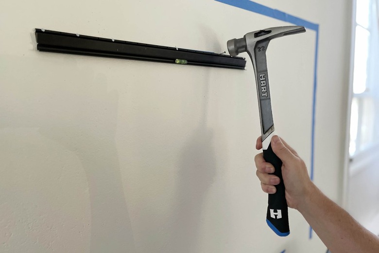 Hammering no-stud TV wall mount onto wall