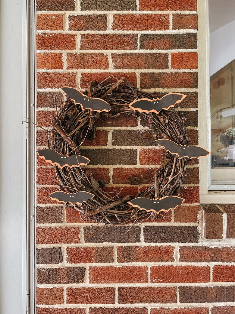 Hang up the finished DIY Halloween Bat Wreath.