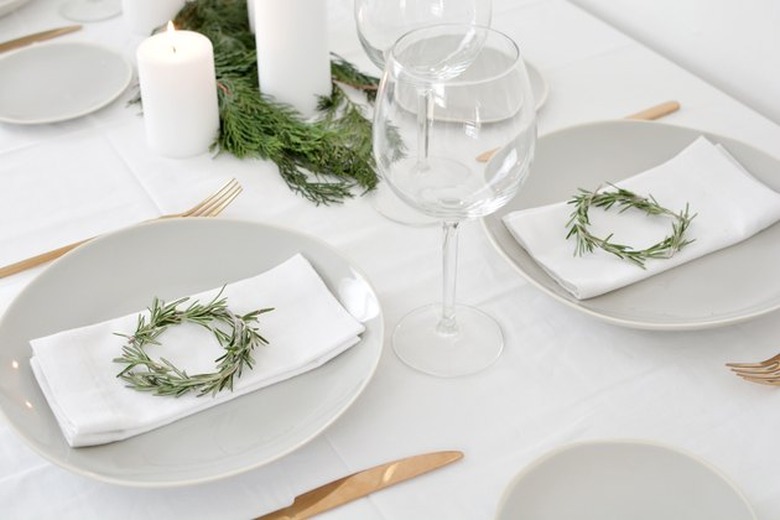 Mini rosemary wreaths for holiday table decor.