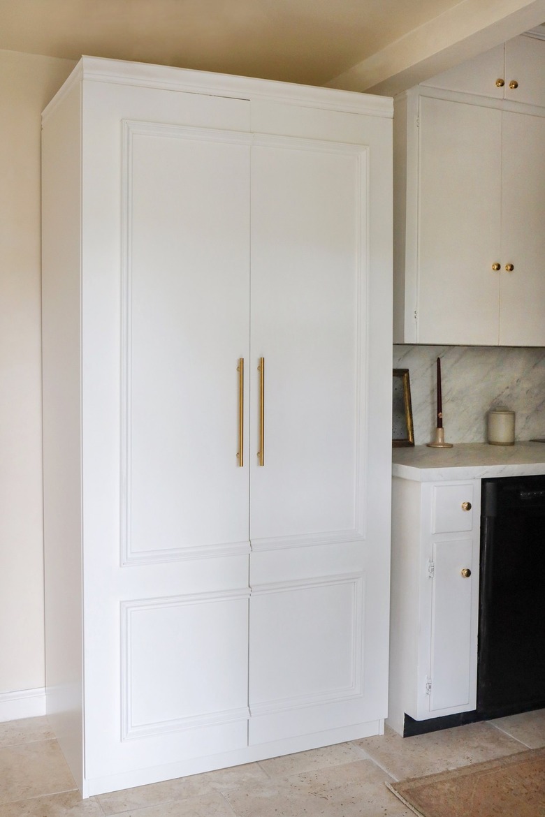 IKEA PAX pantry hack with molding and gold handles in kitchen