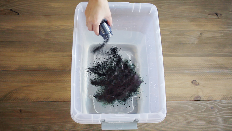 Pouring indigo into water