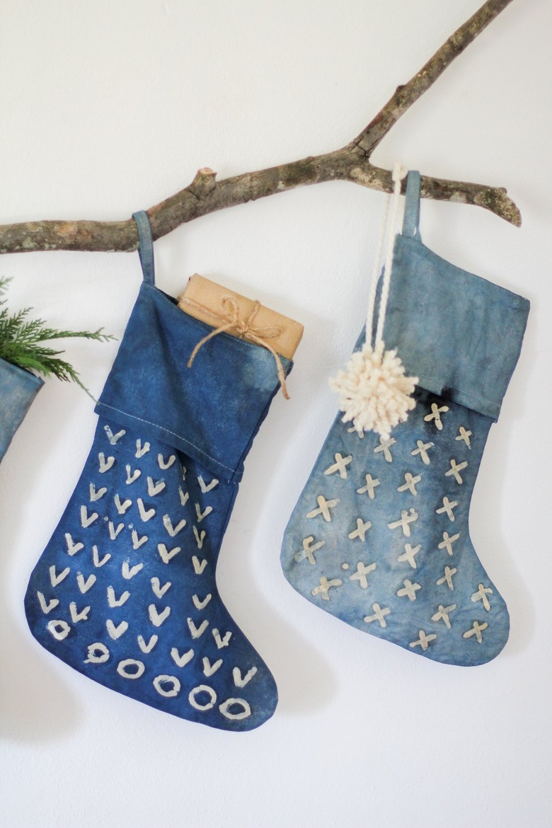 Two indigo stocking and decorative branch