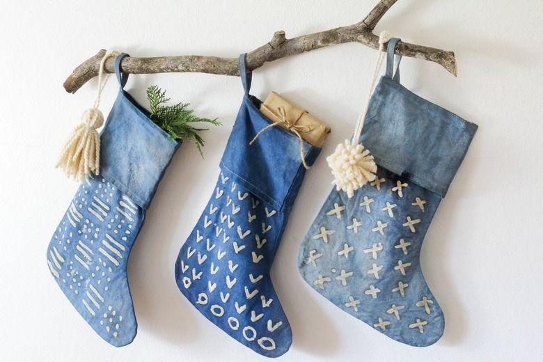 Three indigo stockings with decorative branch