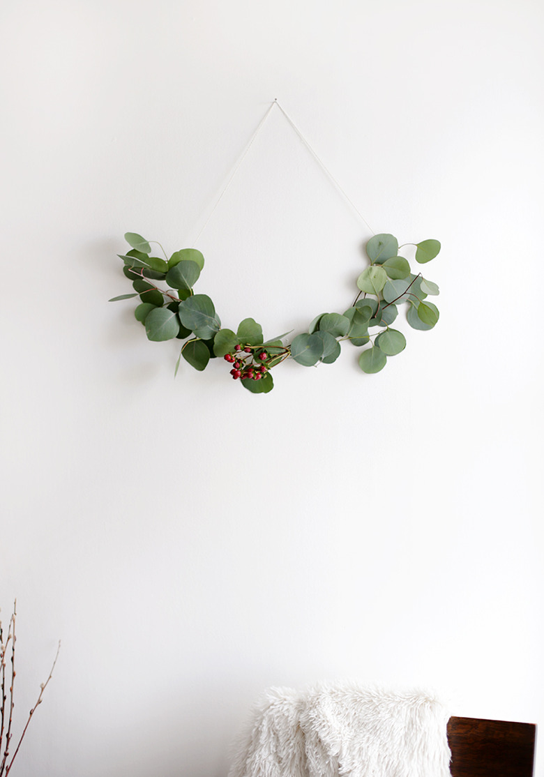 DIY minimalist wreath with greenery on white wall