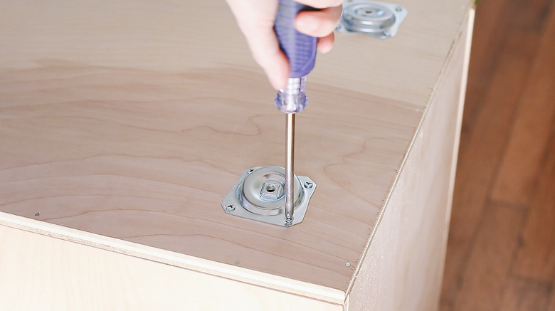 Screwing angle plates for table legs on bottom of box