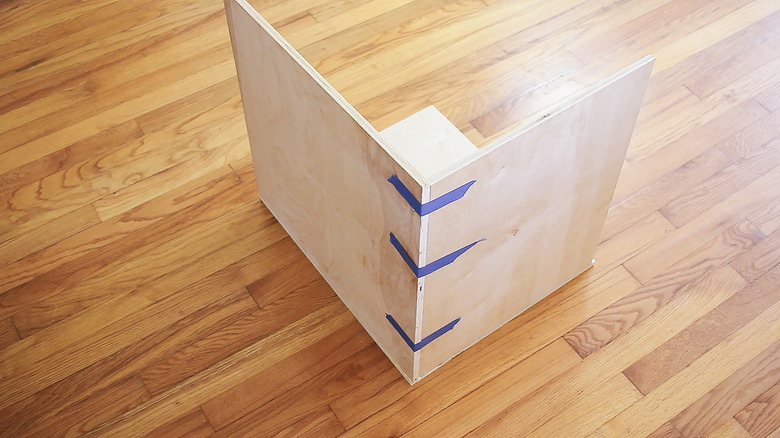 Taping the corners of plywood pieces together