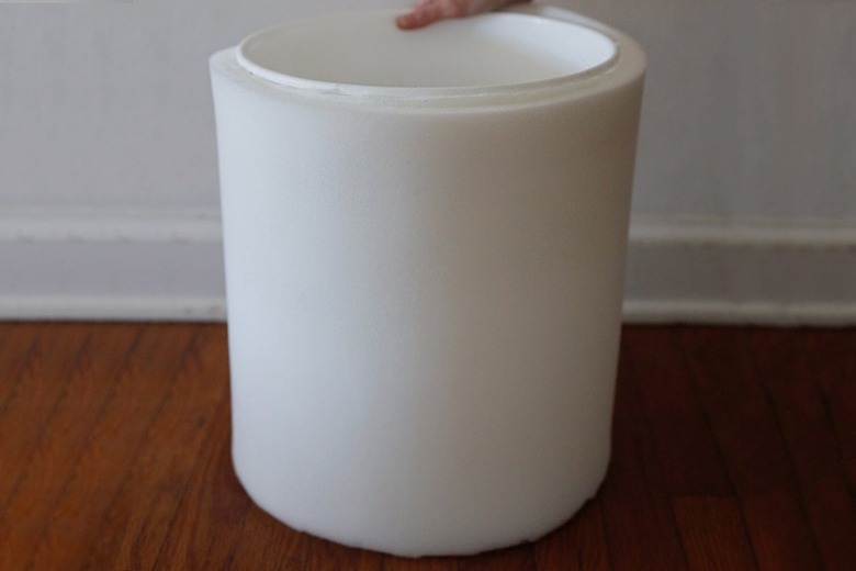 Gluing second layer of 1/2-inch foam to surface of bucket