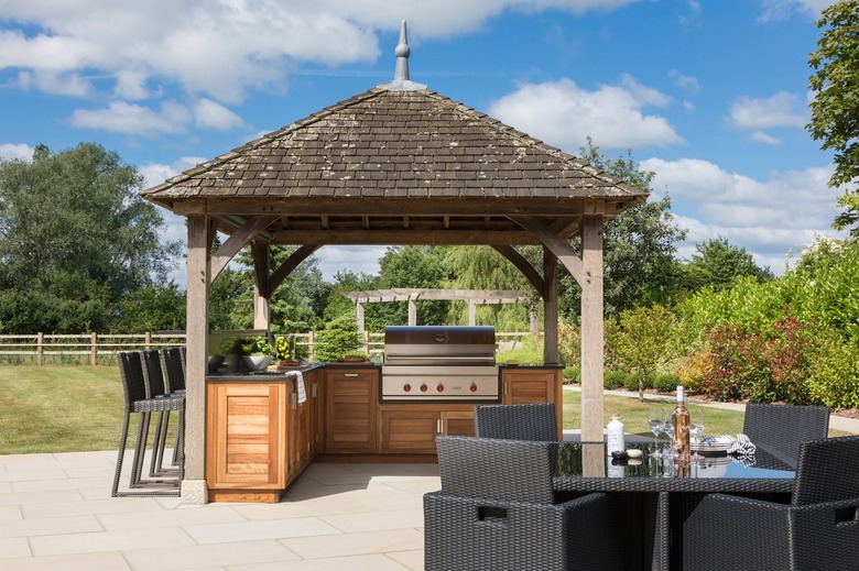 wooden outdoor kitchen under pergola
