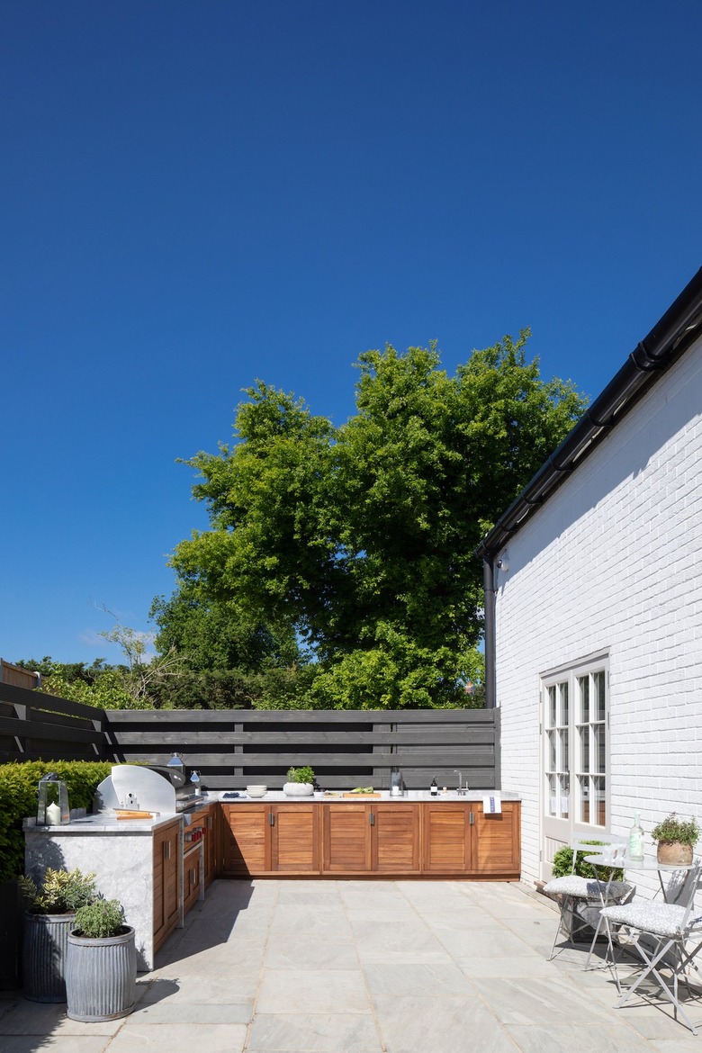 minimal outdoor kitchen with wooden cabinetry