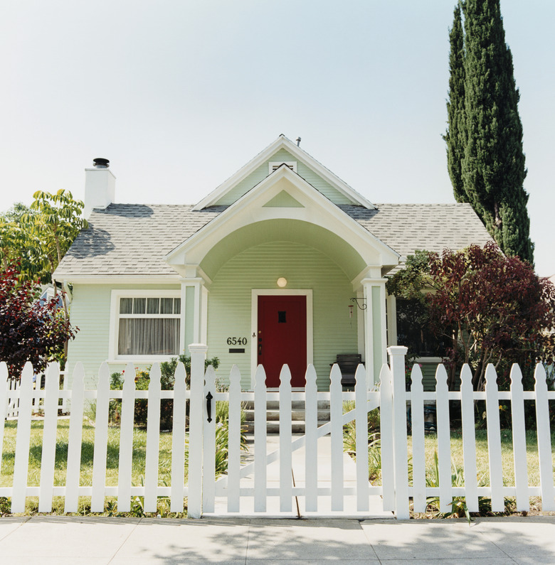 green house with picket fence