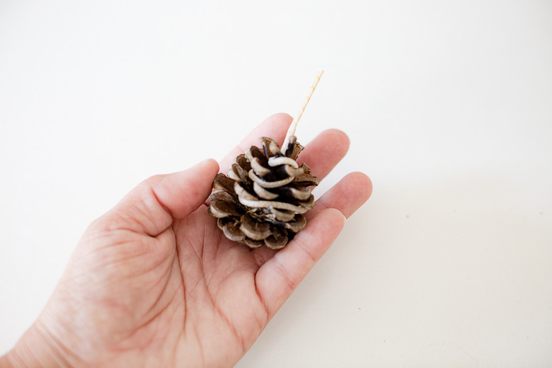 Wick around pine cone