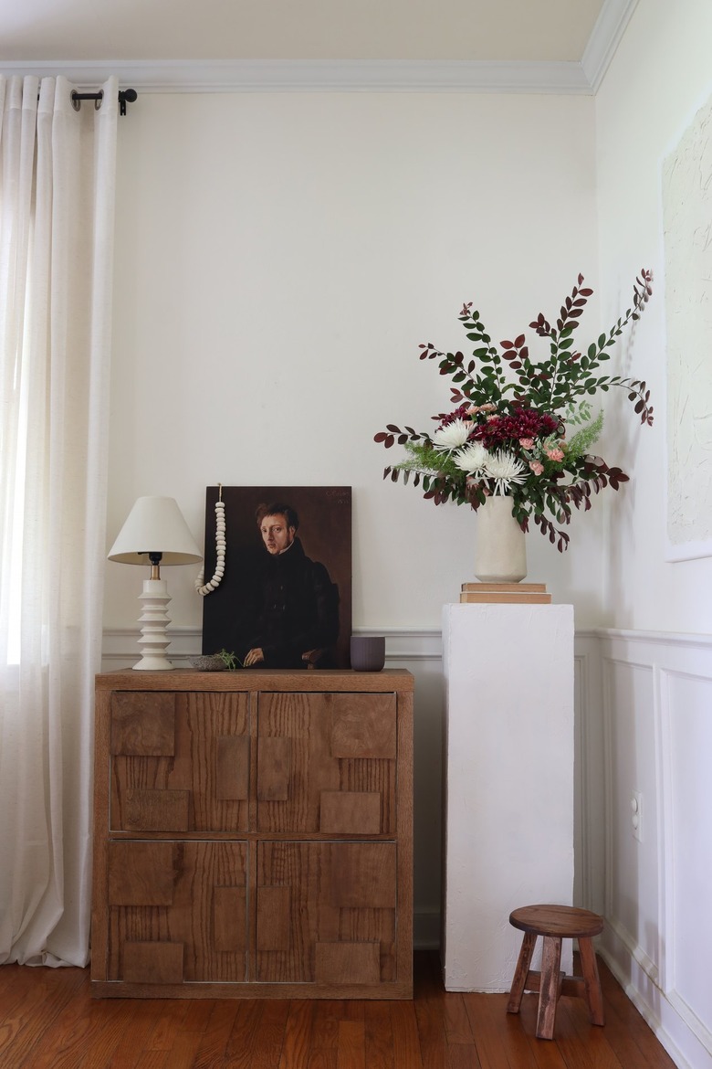 DIY plinth pedestal table stand with flowers next to cabinet
