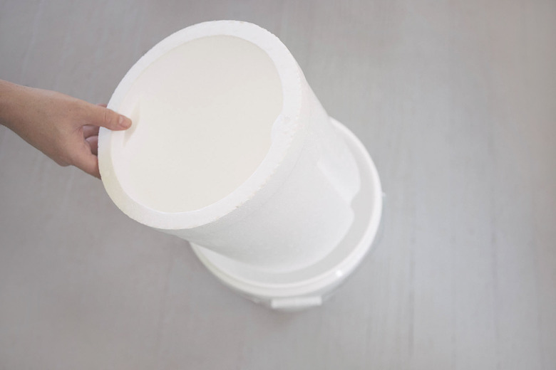 Inserting styrofoam bucket liner insider plastic bucket