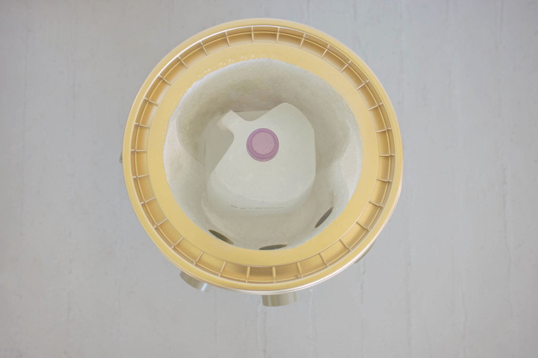 Frozen gallon of water set inside bucket