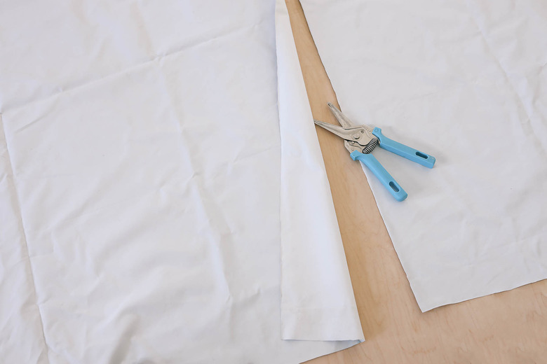 Cutting blackout fabric to size with scissors